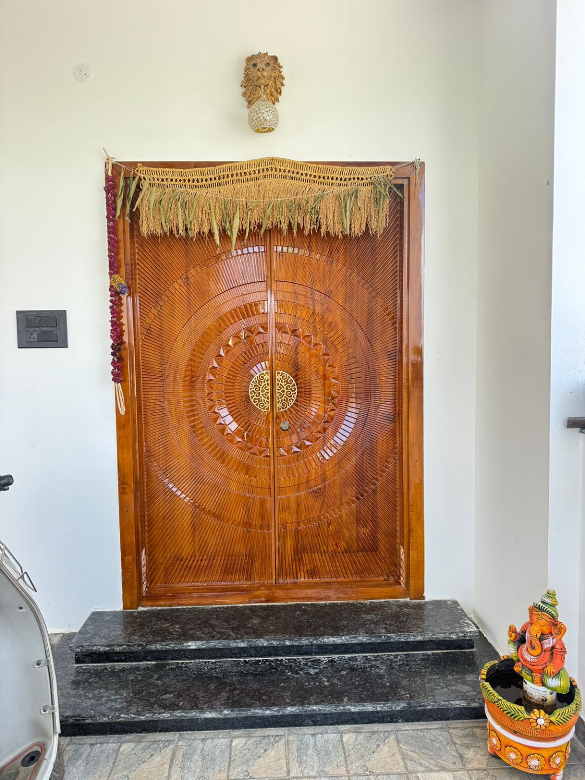 Completed wooden main entrance door by VGP Builders